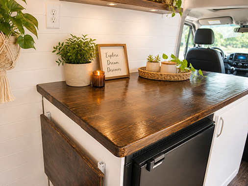 Close-up of a camper van galley with butcher block countertop